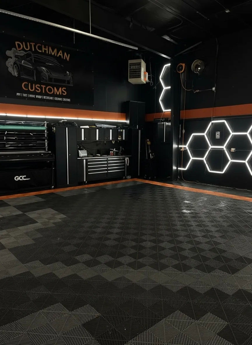 The Dutchman Customs bay: black walls, orange stripe, hexagon lights, checker floor
